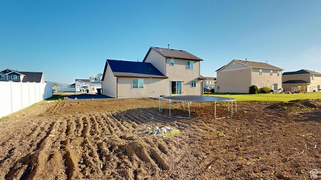 90 W Cedar Ln, Franklin, ID 83237 - back of house with a trampoline, fence, and a residential view