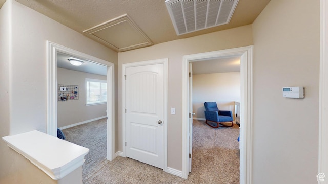 90 W Cedar Ln, Franklin, ID 83237 - hallway with light colored carpet, baseboards, and attic access