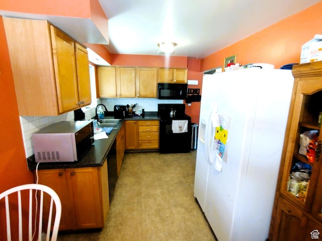 kitchen with black appliances, a sink, decorative backsplash, and dark countertops