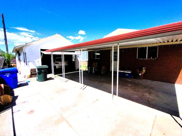 back of house with an attached carport