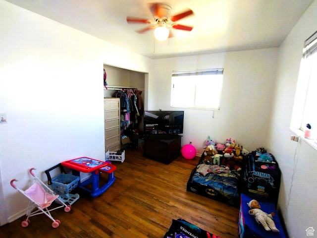 game room with wood finished floors and a ceiling fan
