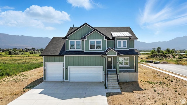 1734 N 4100 W, Plain City, UT 84404 - craftsman house featuring a mountain view, driveway, board and batten siding, and roof with shingles