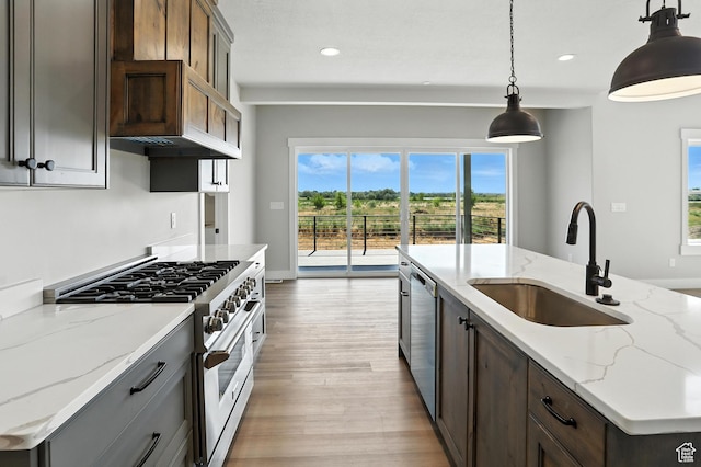 1734 N 4100 W, Plain City, UT 84404 - kitchen featuring appliances with stainless steel finishes, light wood finished floors, recessed lighting, hanging light fixtures, and light stone counters
