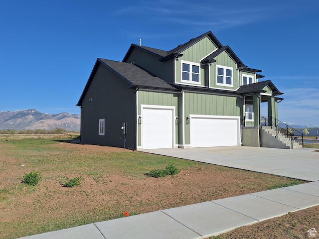 1734 N 4100 W, Plain City, UT 84404 - view of home's exterior featuring concrete driveway, an attached garage, a mountain view, and roof with shingles