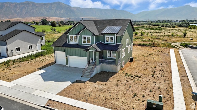 1734 N 4100 W, Plain City, UT 84404 - view of front of house with a shingled roof, concrete driveway, a mountain view, and board and batten siding