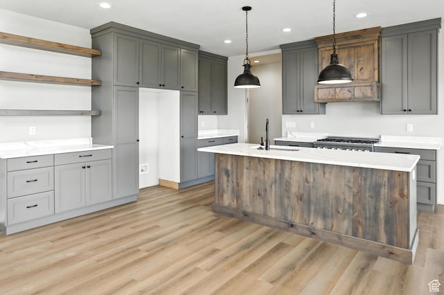 1734 N 4100 W, Plain City, UT 84404 - kitchen featuring open shelves, light wood-style floors, recessed lighting, a center island with sink, and pendant lighting