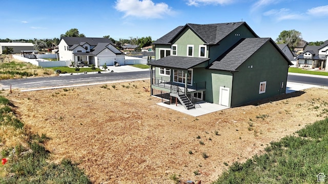 1734 N 4100 W, Plain City, UT 84404 - back of property with stucco siding, a residential view, stairs, and roof with shingles