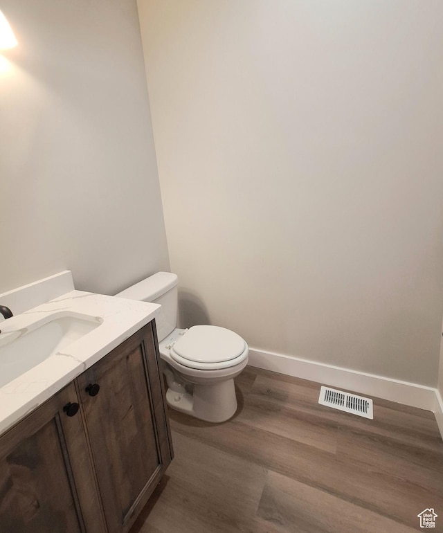 1734 N 4100 W, Plain City, UT 84404 - bathroom with wood finished floors, vanity, toilet, and baseboards