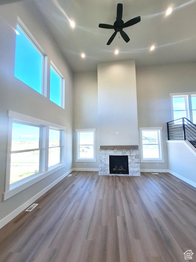 1734 N 4100 W, Plain City, UT 84404 - unfurnished living room with baseboards, wood finished floors, recessed lighting, ceiling fan, and a towering ceiling