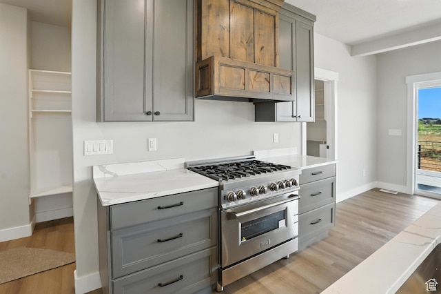 1734 N 4100 W, Plain City, UT 84404 - kitchen with high end stainless steel range, gray cabinets, light wood-style floors, premium range hood, and light stone countertops
