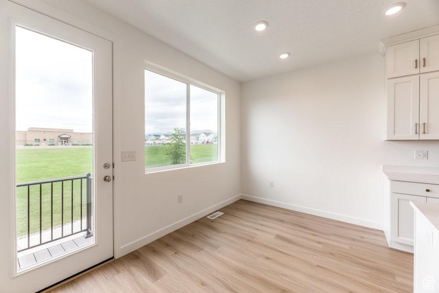 6041 W Lower Ln # 6-234, West Jordan, UT 84081 - doorway to outside featuring light wood-style flooring, recessed lighting, and baseboards
