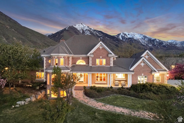 542 E 10000 S, Salem, UT 84653 - view of front of house featuring a tiled roof, a mountain view, brick siding, and a lawn