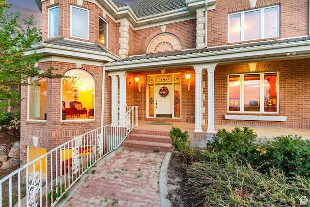 542 E 10000 S, Salem, UT 84653 - exterior entry at dusk featuring brick siding and covered porch