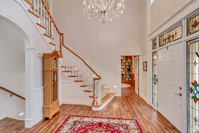 542 E 10000 S, Salem, UT 84653 - entrance foyer featuring a towering ceiling, wood finished floors, arched walkways, a decorative wall, and stairway