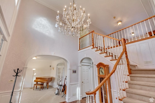 542 E 10000 S, Salem, UT 84653 - stairs with arched walkways, a towering ceiling, a chandelier, and crown molding