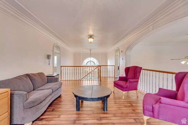 542 E 10000 S, Salem, UT 84653 - living area with arched walkways, ornamental molding, wood finished floors, ceiling fan, and a chandelier
