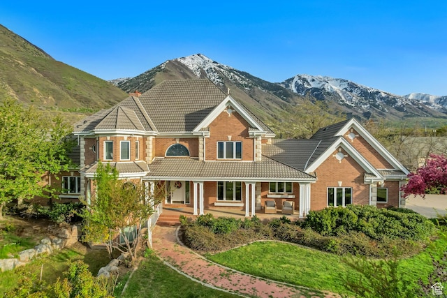 542 E 10000 S, Salem, UT 84653 - view of front facade with a tile roof, brick siding, covered porch, and a mountain view