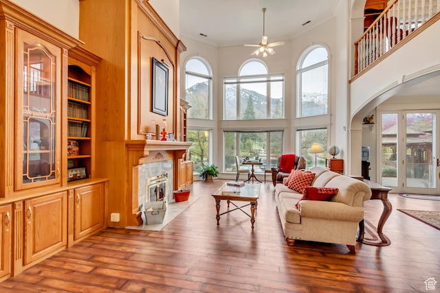 542 E 10000 S, Salem, UT 84653 - living room with a high ceiling, a ceiling fan, a fireplace, arched walkways, and ornamental molding