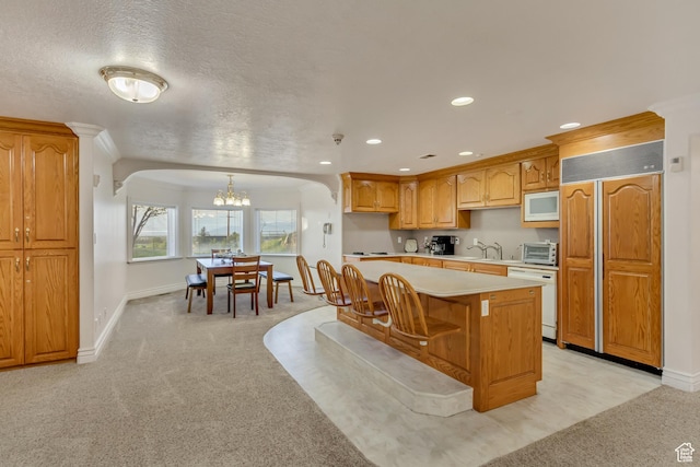 542 E 10000 S, Salem, UT 84653 - kitchen with built in appliances, light countertops, a chandelier, light colored carpet, and recessed lighting