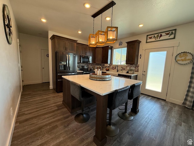 kitchen featuring black appliances, baseboards, dark brown cabinetry, tasteful backsplash, and light countertops