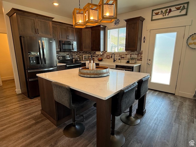 kitchen featuring appliances with stainless steel finishes, dark wood finished floors, decorative backsplash, and recessed lighting