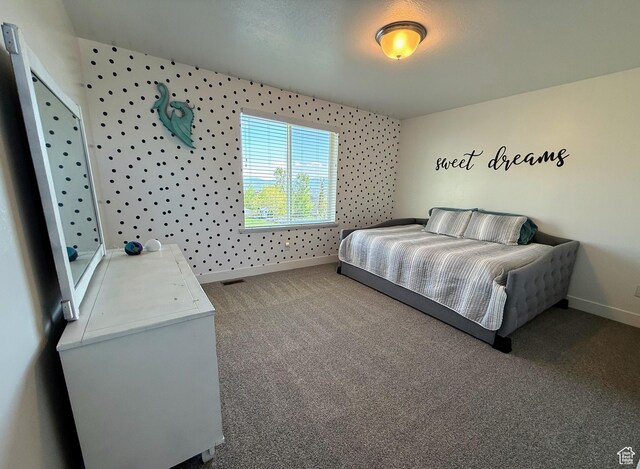 carpeted bedroom featuring baseboards