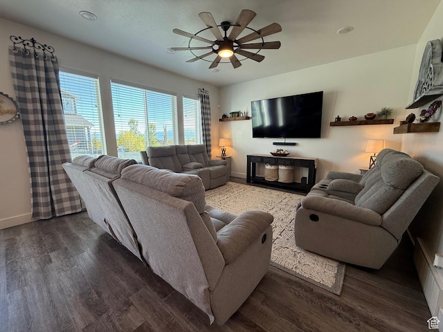 living area featuring ceiling fan, baseboards, and wood finished floors