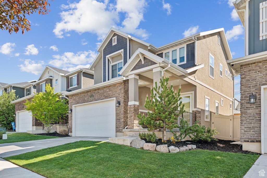 14374 S Abbey Ln, Herriman, UT 84096 - view of front of property with a garage, a front lawn, concrete driveway, stucco siding, and stone siding