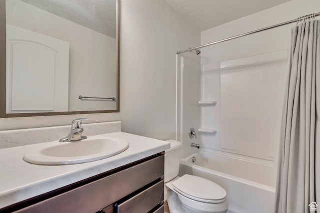 bathroom featuring toilet, vanity, and shower / bath combo with shower curtain