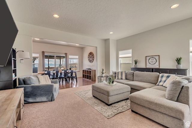 living room with recessed lighting and a textured ceiling