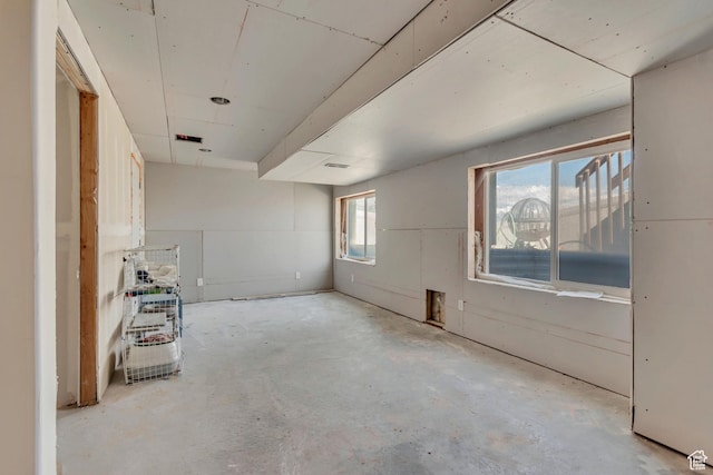 unfurnished room with concrete floors