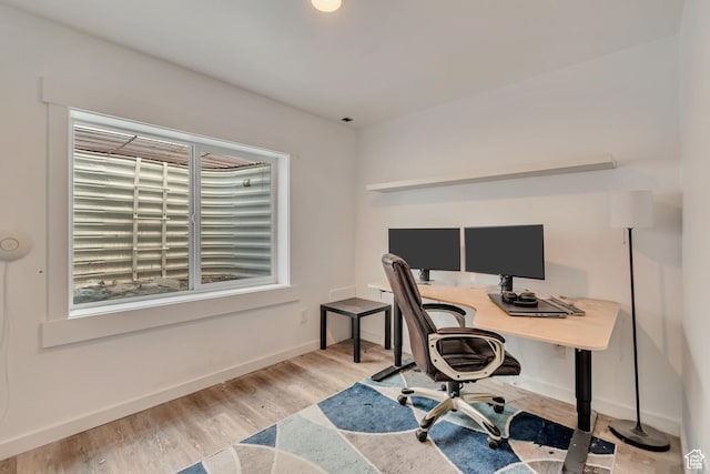 home office with wood finished floors and baseboards