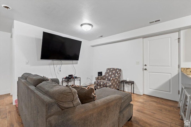 living area with hardwood / wood-style flooring and baseboards