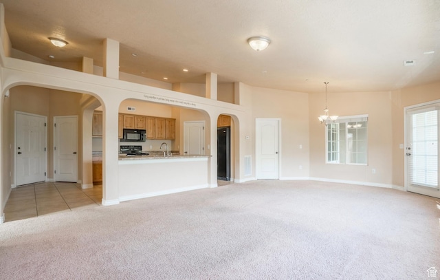 1195 W Dallin Dr N Unit R301, Pleasant Grove, UT 84062 - unfurnished living room with light colored carpet, a chandelier, a sink, arched walkways, and baseboards