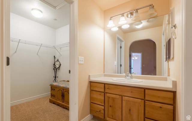 1195 W Dallin Dr N Unit R301, Pleasant Grove, UT 84062 - bathroom featuring a spacious closet, vanity, and baseboards