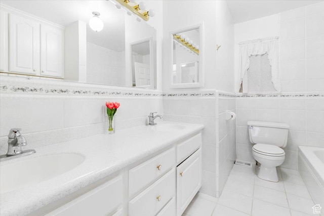 377 N 300 E, Nephi, UT 84648 - bathroom featuring tile walls, tile patterned flooring, toilet, double vanity, and a tub