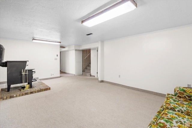 377 N 300 E, Nephi, UT 84648 - finished basement with a wood stove, baseboards, stairway, light colored carpet, and a textured ceiling