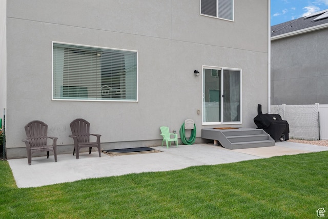 rear view of property featuring a patio area and stucco siding