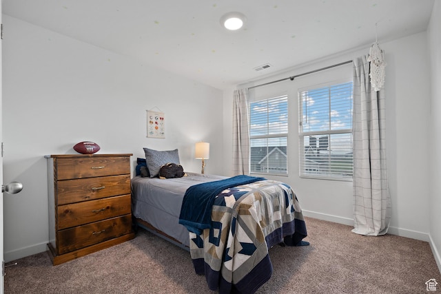 bedroom with carpet flooring and baseboards