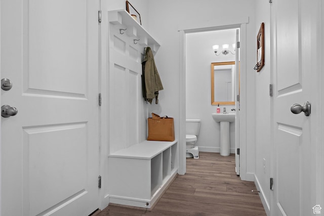 mudroom with wood finished floors and baseboards