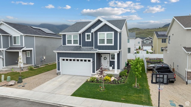view of front of property featuring board and batten siding, concrete driveway, a residential view, a shingled roof, and an attached garage