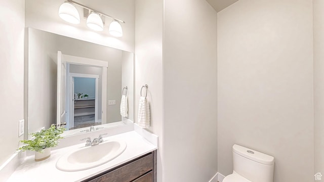 half bath featuring toilet and vanity