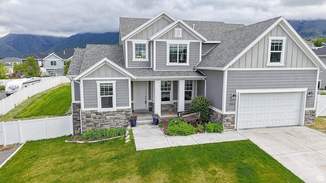 craftsman house with board and batten siding and stone siding