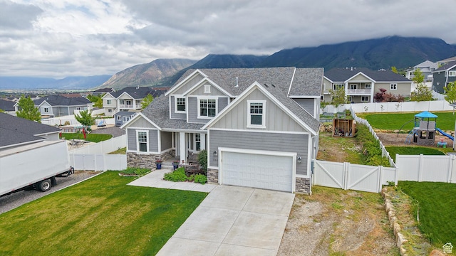 craftsman inspired home featuring board and batten siding, stone siding, and a mountain view