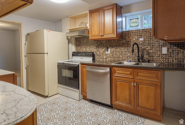 kitchen featuring electric stove, dishwasher, freestanding refrigerator, a sink, and brown cabinets
