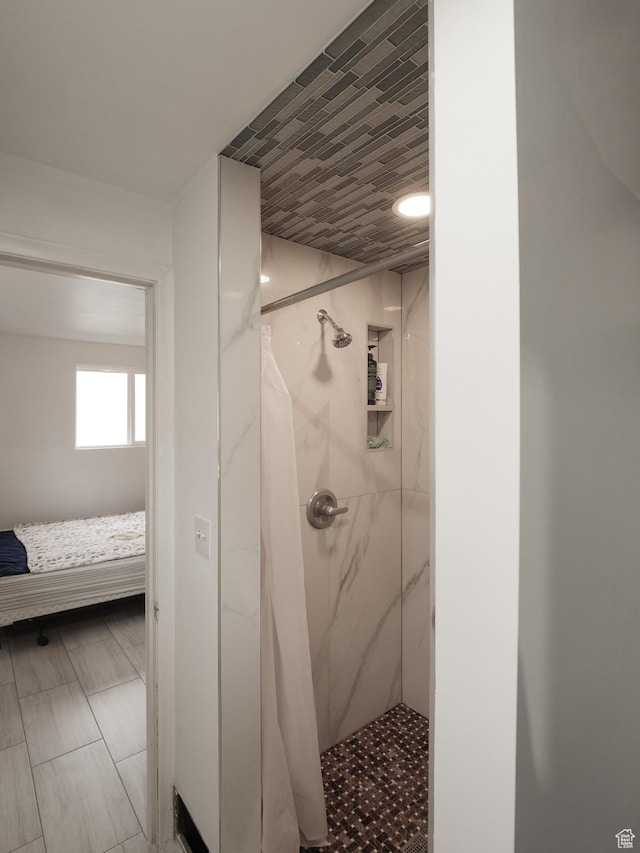bathroom with a marble finish shower