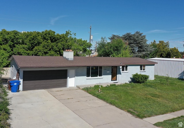 ranch-style home featuring a garage, a front lawn, driveway, a chimney, and a shingled roof