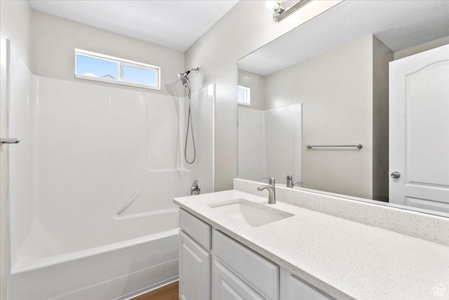 full bath featuring vanity and washtub / shower combination