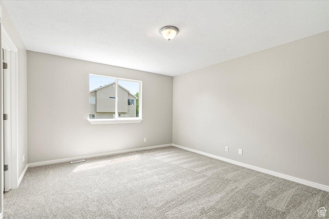 unfurnished bedroom featuring carpet and baseboards