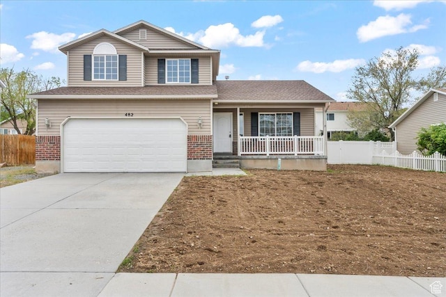view of front of property featuring covered porch, brick siding, fence, a garage, and concrete driveway